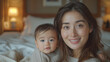 © JMarques - Mother and baby happy at home. Asian mother taking care of her baby, concept of love between mother and child. Motherhood and family