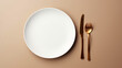 
Minimalist Table Setting with White Plate and Copper Cutlery on Beige Background