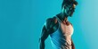 © Brian - Fit young man wearing tank top and posing on solid bluebackground