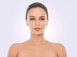 © Mariusz S/peopleimages.com - Girl, skincare and face in studio for beauty with natural look, cosmetics and dermatology for wellness. Woman, portrait and clean for self care, mockup and white background with topless serious model