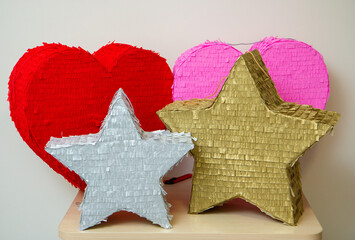 Wall Mural - bright piñatas for birthday celebrations, hearts and stars made of cardboard