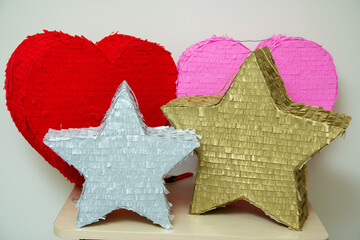 Wall Mural - bright piñatas for birthday celebrations, hearts and stars made of cardboard