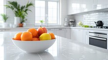 A Bowl Of Citrus Adds A Pop Of Vibrant Color And Freshness In A Light-toned Modern Kitchen. Inspiring Fruit Bowl In A Contemporary Setting.