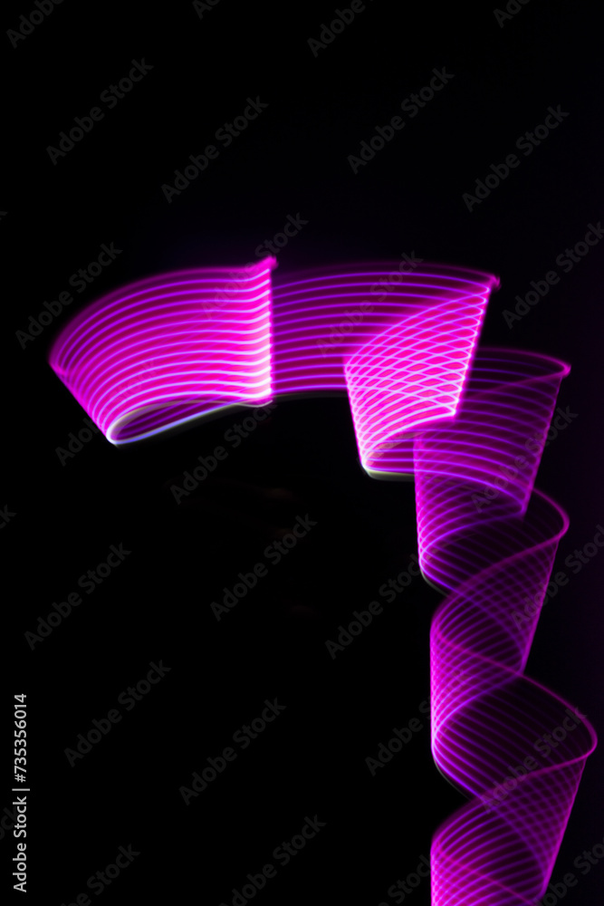 Pink and purple shining neon wave of light as curls or swirl with ...