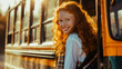 © Ed - Red-haired laughing girl boarding the bus to high school, space for education and back to school concept