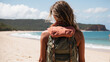 back view of a female backpacker with an beach in the background