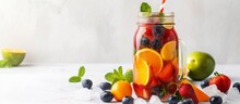 Fresh And Colorful Assortment Of Fruits In A Jar Next To A Refreshing Glass Of Water On A Sunny Day