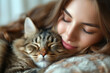 © Spicy World - Young beautiful woman embraces her furry cat, eyes shut