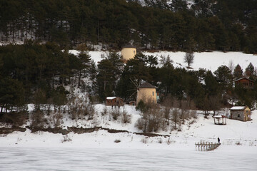 Wall Mural - Beautiful view of windmills around Lake Çubuk, located in Bolu - Goynuk district of Turkey. Photo of mills in snowy weather in winter.