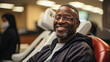 African american man exudes warm, relaxed demeanor as he sits comfortably in waiting room, his friendly smile reflecting moment of ease amidst hustle