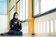 © maya1313 - Ramadan, The image of an Asian Muslim woman in the Islamic religion in hijab in black color. reading the Quran and having a happy smiling face Staying in a beautiful mosque out of respect for God.