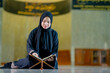 © maya1313 - Ramadan, The image of an Asian Muslim woman in the Islamic religion in hijab in black color. reading the Quran and having a happy smiling face Staying in a beautiful mosque out of respect for God.
