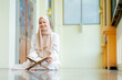 © maya1313 - Ramadan, quran, The image of an Asian Muslim woman in the Islamic religion in hijab in cream color. reading the Quran and having a happy Staying in a beautiful mosque, Arabic word Holy Al Quran.