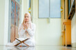 © maya1313 - Ramadan, quran, The image of an Asian Muslim woman in the Islamic religion in hijab in cream color. reading the Quran and having a happy Staying in a beautiful mosque, Arabic word Holy Al Quran.