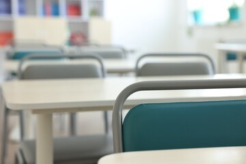 Wall Mural - Empty school classroom with desks and chairs