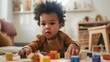 © ND STOCK - a young toddler playing with wooden block toys
