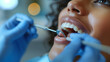 © Fokke Baarssen - close up of a woman sitting in a dental chair at a medical center while a professional doctor fixing her teeth, a Dentist examining a patient's teeth in the dentist