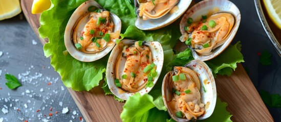 Canvas Print - A wooden cutting board displaying a mixture of clams and fresh lettuce, ready to be used as ingredients in a delicious recipe.