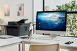 © Clique Images - No people shot of modern desktop computer and printer on desk in modern office interior, copy space