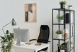 © Clique Images - No people shot of modern workplace design in office with computer on table, comfortable chair, houseplants on floor and shelves