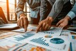 © BOONJUNG - Business photography, Group of business people point to graphs and charts to analysis market data