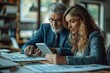 © Iona - Business professionals analyzing data on a tablet in an office setting