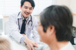 © chokniti - Professional male doctor in white medical uniform talk discuss results or symptoms with female patient, man GP or physician consult client give recommendation at meeting in hospital, health insurance