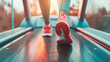 © wanchai - A person jogging on a treadmill at dusk, fitness and health concept in an indoor setting.