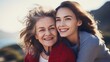 Two smiling women of different ages looking at different side holding hand closeup portrait. Young girl cuddling snuggling mom.  Relation between parent and adult kid