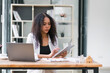 © PRIME STOCK LAB - Young African American professional woman using a tablet at work.