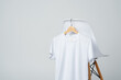 © fotofabrika - White blank t-shirt hanging on chair in empty room