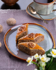 Wall Mural - Novruz pastry - shekerbura, pakhlava, sweet kete, bishi, badambura on white tablecloth in Novruz setting with festive wheat grass and pear shape eastern glasses with tea, New year celebration in Baku