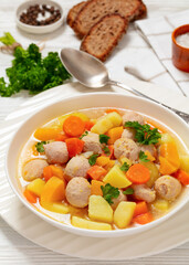 Wall Mural - finnish sausage soup with vegetables in white bowl