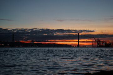 Wall Mural - Sunset on Tagus river in Lisbon. View on Bridge