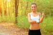 © George Anchev/peopleimages.com - Outdoor, portrait and woman with thumbs up for fitness in woods or forest for exercise. Workout, achievement and girl smile in summer, nature or park with happiness, pride and runner sign for yes