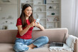 © Prostock-studio - Young Smiling Asian Woman Using Smartphone And Laptop At Home