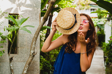 Wall Mural - attractive young woman in blue dress and straw hat