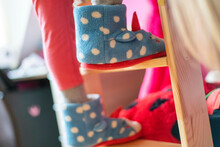 Young Girl Climbing Her Bunkbed With Fluffy Slipper Shoes On