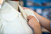 Female Seamstress Adjusting A Shirt Collar