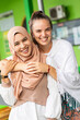 © Connect Images - A smiling portrait of a young muslim woman and her friend outside her mosque in southern Thailand