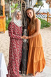 © Connect Images - Portrait of two female best friends, one is wearing a hijab in a beach resort in southern Thailand.