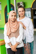© Connect Images - A portrait of a young muslim woman and her friend outside her mosque in southern Thailand