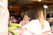 © Connect Images - Two young women one wearing a Hijab   sitting together in a cafe restaurant in a rural town in Thailand