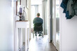 © Image Source - Man in wheelchair leaving the house to go to the shops