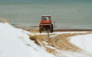 Wall Mural - Old tractor on the seashore.