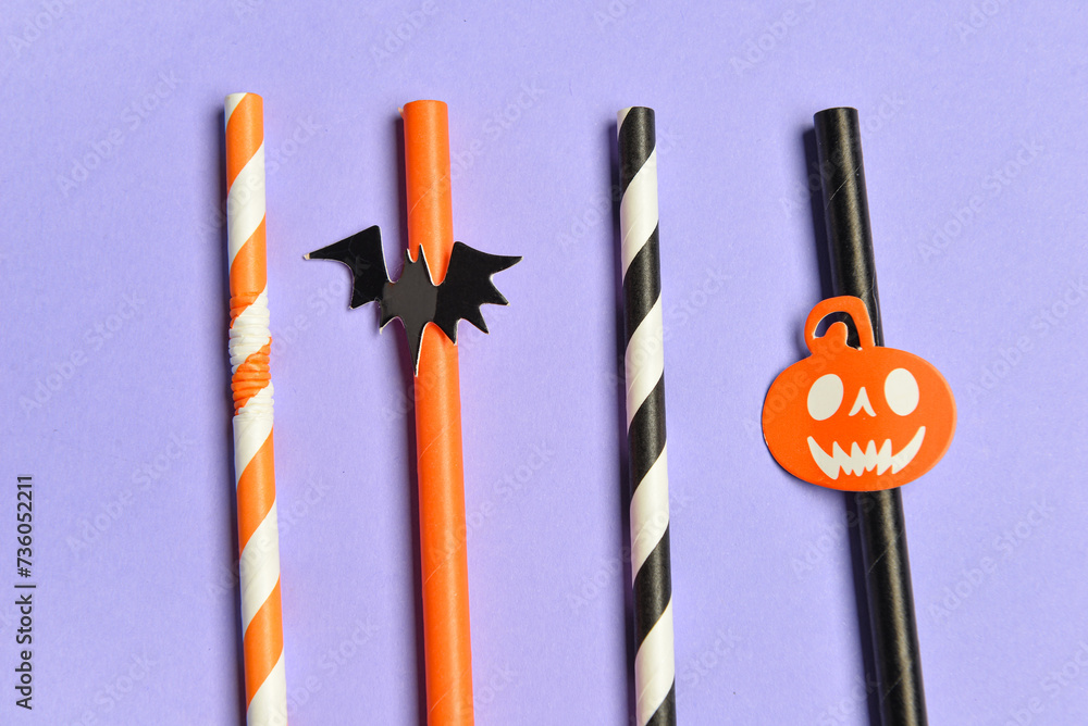 Set of different drinking straws for Halloween celebration on color background, closeup