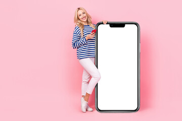 Wall Mural - Full length photo of pretty funny woman dressed striped shirt texting modern gadget empty space isolated pink color background