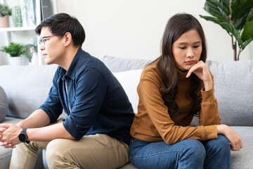 Wall Mural - Family problem concept, Close-up hands of Asian wife sitting on sofa and husband sitting back to back in the living room at home have problems in a relationship and have an argument