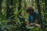 Fototapeta  - Botanist Man working on a laptop computer in the forest researching nature