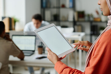 Leinwandbilder - Tablet with blank screen in hands of young Muslim female manager standing in front of camera in coworking space